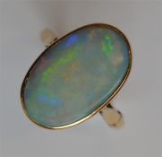A large opal single stone ring in 9 carat rubover