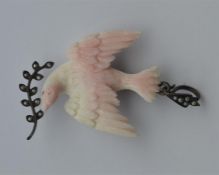 An Antique coral pendant in the form of a bird wit