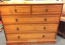 A massive stripped pine chest of three long and tw