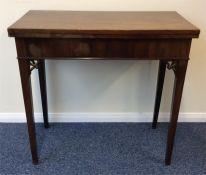 A mahogany hinged topped games table with tapering