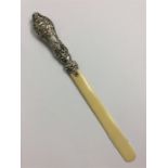 A small cherub decorated silver mounted paper knif