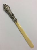 A small cherub decorated silver mounted paper knif
