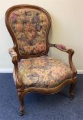 A late Victorian button back armchair with floral