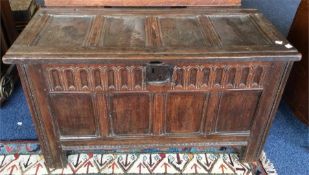 A small 18th Century oak coffer with carved decora