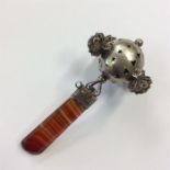 An unusual silver rattle with filigree and agate d