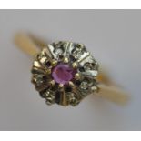 An 18 carat ruby and diamond cluster ring. Approx.