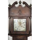 A large tall mahogany grandfather clock with paint
