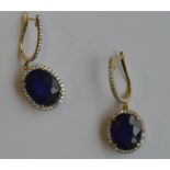 A pair of large diamond and sapphire earrings in t