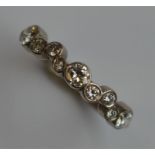 An 18 carat 9 stone half eternity ring in collet m