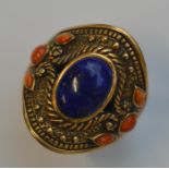 A large coral mounted college ring with lapis cent