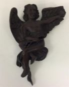 An unusual carved bracket in the form of a winged