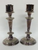 A pair of EPNS candlesticks with fluted design. Es