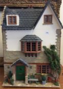 An attractive doll's house in the form of a quaint