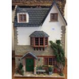 An attractive doll's house in the form of a quaint