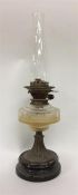 An old brass mounted oil lamp with glass reservoir