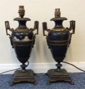 A pair of unusual brass mounted oil lamps on squar