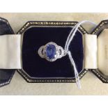 An attractive sapphire and diamond oval cluster ri