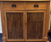 A good stripped pine glazed two door cabinet on bu
