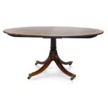 A 19th century mahogany and yew crossbanded circular tilt-top table on four reeded legs by William