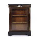 A Victorian ebonised and gilt metal mounted pier cabinet with an enamelled roundel on a plinth base,