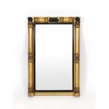 An early 19th century giltwood and ebonised wall mirror,