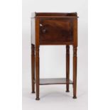 A Victorian mahogany pot cupboard with a single door over a second tier on circular tapering legs,
