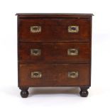 A 19th century mahogany campaign style chest of three drawers with recessed brass handles on bun