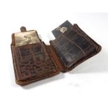 An early 20th century leather case containing a group of glamour photographs taken in parlours and