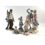 A late 19th century figural group modelled as a dandy and his companion together with a group of