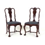 A set of twelve George I-style mahogany dining chairs on cabriole legs with serpentine stretchers