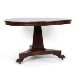 A William IV rosewood circular tilt-top dining table on a triangular column,