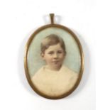 A late 19th century pendant containing a miniature overpainted photograph head and shoulders