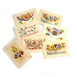 A collection eight coloured silk embroidered postcards sent from France during WWI by a member of