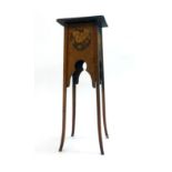 A late 19th/early 20th century mahogany and carved jardiniere stand