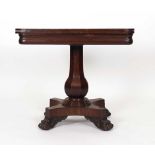 A 19th century mahogany games table, the folding top over a bulbous column,