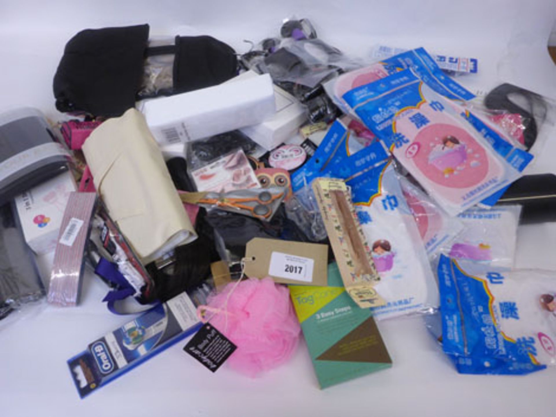 Bag containing hair pieces, makeup brushes, false eyelashes, razors, compact mirrors etc