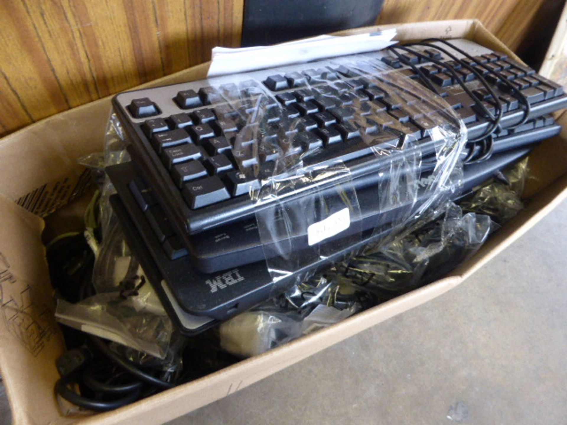 2054 Box containing various computer cables and keyboards