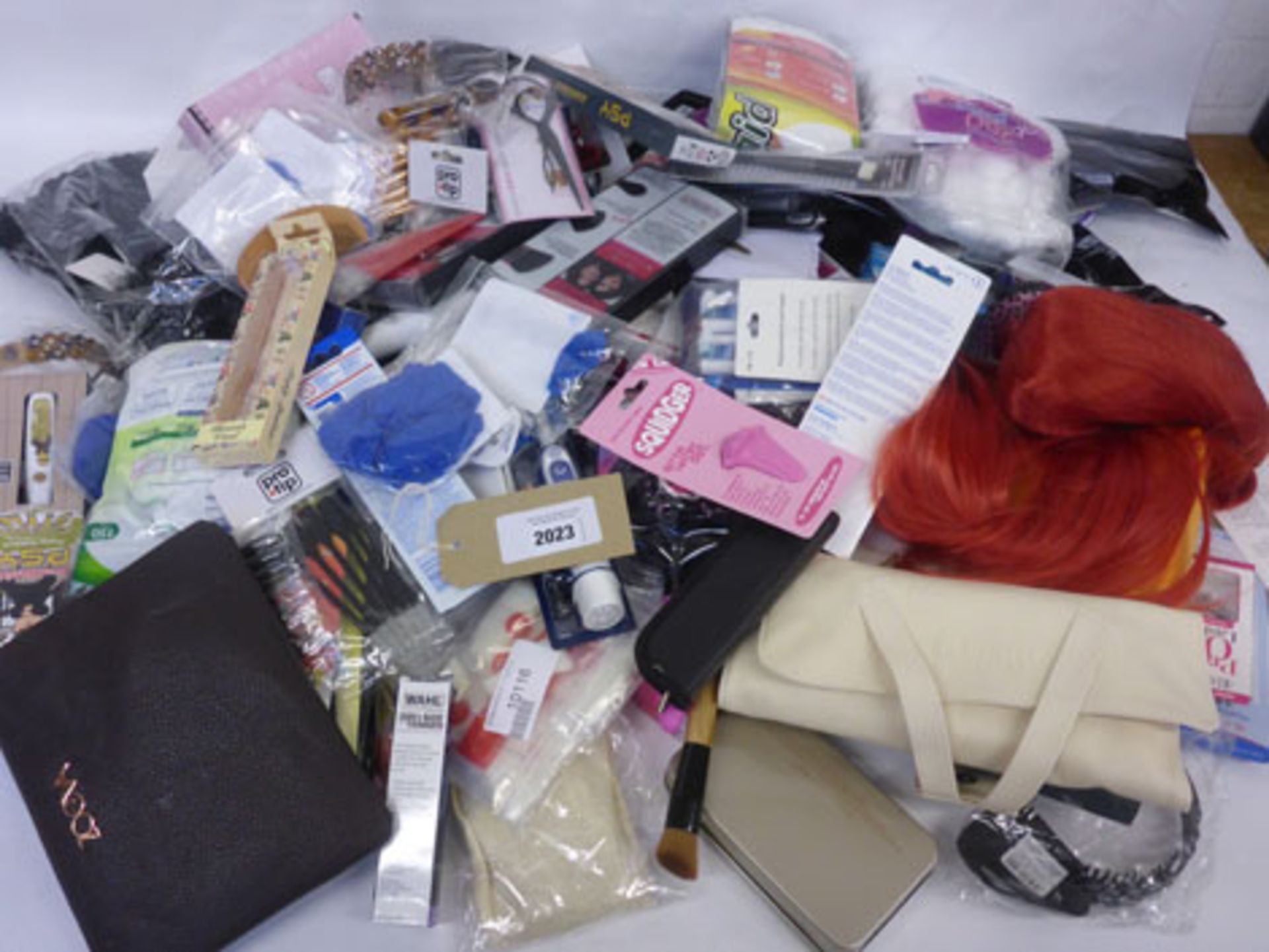 Bag containing toothbrush heads, makeup brushes, wigs, hair pieces, Gillette razors, false nails,