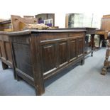 An 18th century oak panelled coffer on square straight stiles, l.