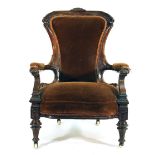 An Edwardian mahogany and upholstered open armchair on turned front feet