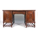 An early 20th century Continental oak twin pedestal desk with carve doors on barley twist supports,