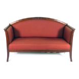 A Regency-type mahogany and upholstered sofa with a curved back and swept feet