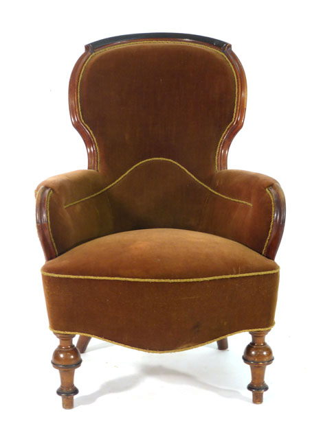 A Victorian mahogany and upholstered balloon back armchair on turned front legs CONDITION