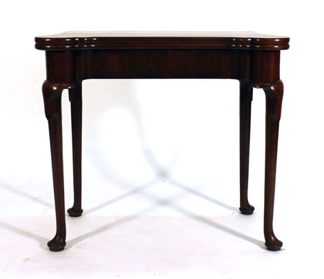 A George II and later mahogany tilt-top games table on cabriole legs and pad feet, w.