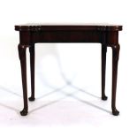 A George II and later mahogany tilt-top games table on cabriole legs and pad feet, w.