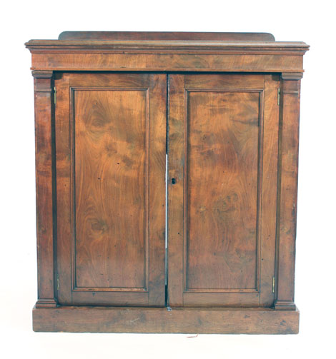 A 19th century mahogany cabinet, the two solid doors flanked by pilasters on a plinth base, w.