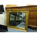 A rectangular wall mirror, th plate within a gilt plaster frame,