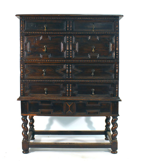 A 17th century-type oak and bevelled four drawer chest on stand, w.