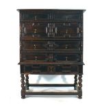 A 17th century-type oak and bevelled four drawer chest on stand, w.