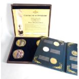 Two cases containing eight gold plated and Swarovski crystal set medallions from the 'Portraits of